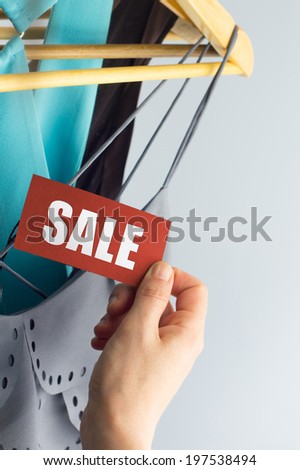 sale, elegant clothes with tags bid, with hand