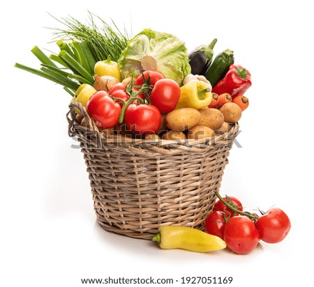 Large basket of vegetables. Potatoes, tomatoes, onions, cabbage, paprika, zucchini, eggplant. Isolate on white background