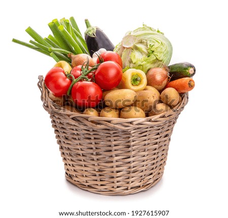 Large basket of vegetables. Potatoes, tomatoes, onions, cabbage, paprika, zucchini, eggplant. Isolate on white background