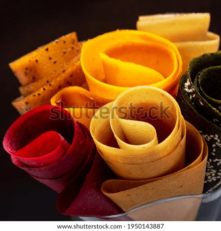 Multicolored fruit marshmallow rolled into rolls on black background 
 Сток-фото © 
