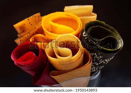 Multicolored fruit marshmallow rolled into rolls on black background 
 Сток-фото © 