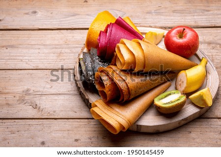 Multi-colored fruit marshmallow, rolled up on a wooden board and fruits. background  Сток-фото © 