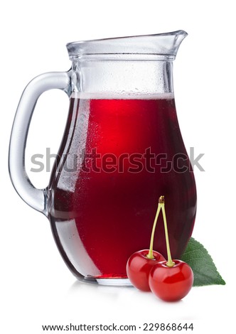 Cherry juice in a misted pitcher. Full jug of sour cherry juice with cherries on foreground