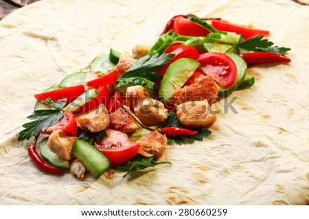 Traditional unfolded shawarma with chicken and vegetables just before wrapping