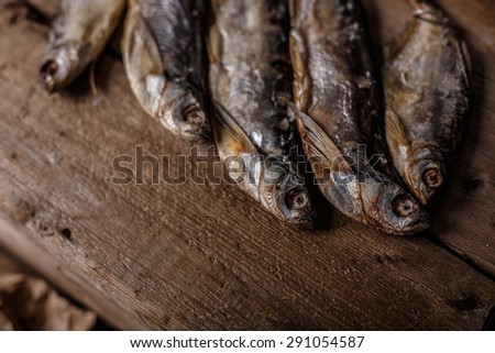 Dried fish on wooden table. Selective focus, narrow depth of field.