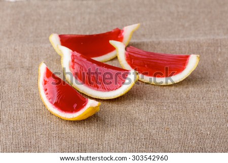 Lemon tequila strawberry jelly (jello) shots on a linen clothed table. Unusual adult party drinks