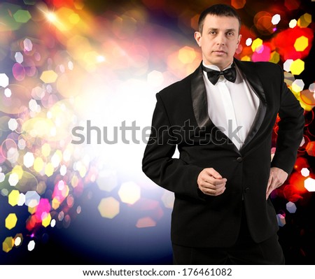 Valentine Day.Holiday Night Party.Men in a Classical Tuxedo on an Night Party abstract dark background