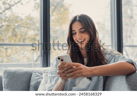 Similar – Image, Stock Photo Young millennial woman in white shirt taking a selfie or videochatting on mobile phone sitting on the steps of a building. Female student using technology sitting on staircase steps of university campus. Real people with mobile phones.