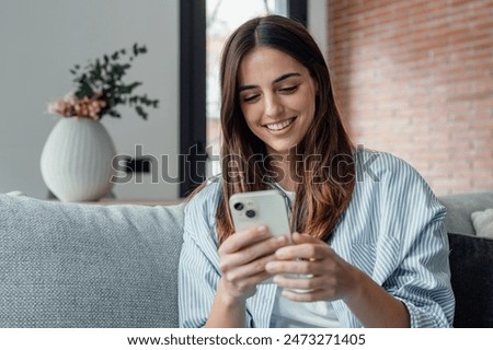 Similar – Image, Stock Photo Young millennial woman in white shirt taking a selfie or videochatting on mobile phone sitting on the steps of a building. Female student using technology sitting on staircase steps of university campus. Real people with mobile phones.