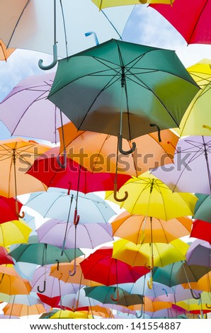 A lot of multicolored umbrellas over the sky