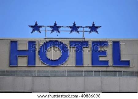 Hotel facade. Word is in blue with neon