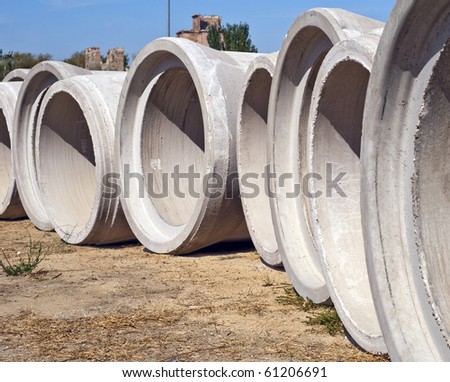 Some concrete tubes in the ground. Construction concept
