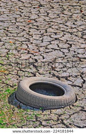 Old tyre in a dry river. Environmental, ecology and climate change concept