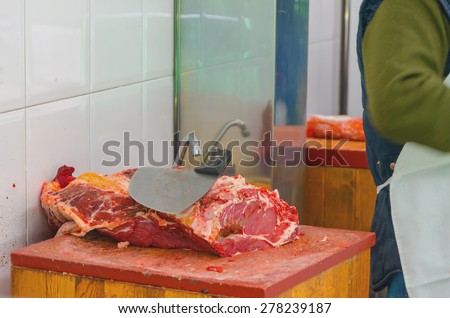 Butcher knife in the butchery. Raw meat preparation