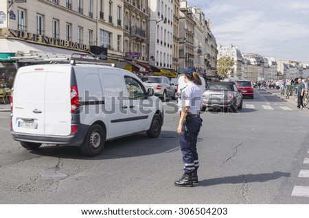 PARIS, FRANCE - september 17, 2014: Policewoman in the streets of Paris. The National Police is the main civil law enforcement agency of France.