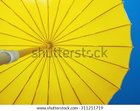 Yellow umbrella open against the sky. Protection shadow. Parasol