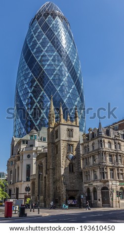 CENTRAL LONDON / ENGLAND - 18.05.2014 - The Gherkin sky-scraper is seen centrally behind the St. Andrew Undercroft medieval church in London.