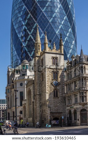 CENTRAL LONDON / ENGLAND - 18.05.2014 - The Gherkin sky-scraper is seen behind the St. Andrew Undercroft medieval church in London.