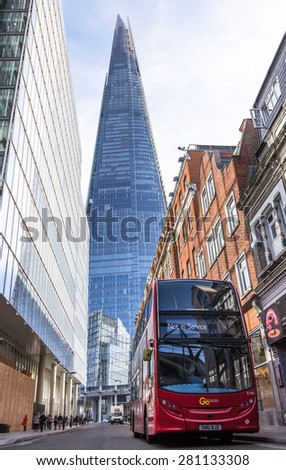 LONDON, UK / 07.03.2015 - Wide shot of London bus in front of The Shard sky scraper