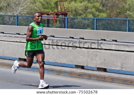 BELGRADE, SERBIA - APRIL 17: An unidentified man run during 24th Belgrade Marathon 2011. on April 17, 2011. in Belgrade, Serbia. Reda Gobreslassie Tsegaye finished first with 2 hours 14 mins 41 secs