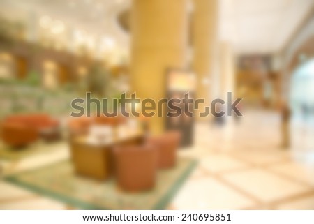 Abstract blurry bright reception area with few people in warm light ambient