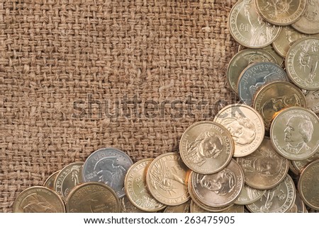 Group of one dollar coins copyspace over used old sack background