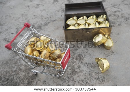 Abstract shallow DOF of gold transfering from treasure chest by pushcart with chineses word crafted on gold with meaning of good fortune, best of luck, and good health