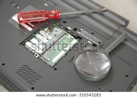 Finding computer issue by examining mainboard pcb using magnifier glass