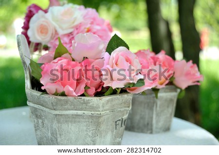 Decorative artificial roses flowers in vase outdoor