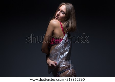 Photo of woman\'s back in foil on black background