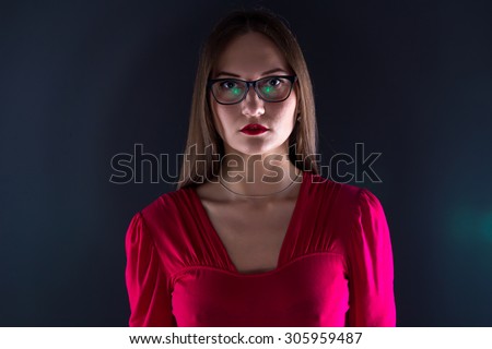 Photo of woman in red, shadows on black background