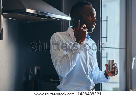 Similar – Image, Stock Photo Elegant black man talking smartphone leaning building