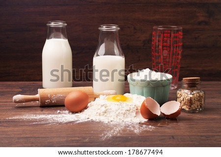 A measuring glass, bottles of milk and other ingredients