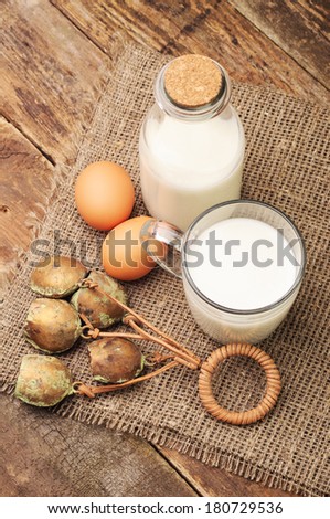 Cowbell with milk and eggs on the table