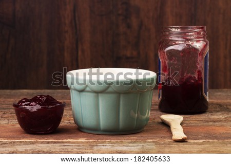A fruit jam jar and a bowl of cream