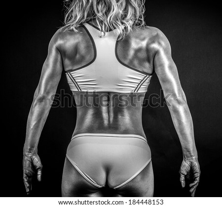 Black and white photo of a strong woman from behind