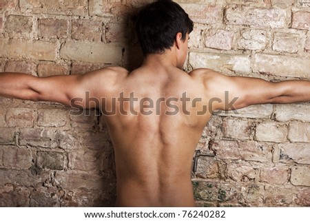 Man is posing near wall