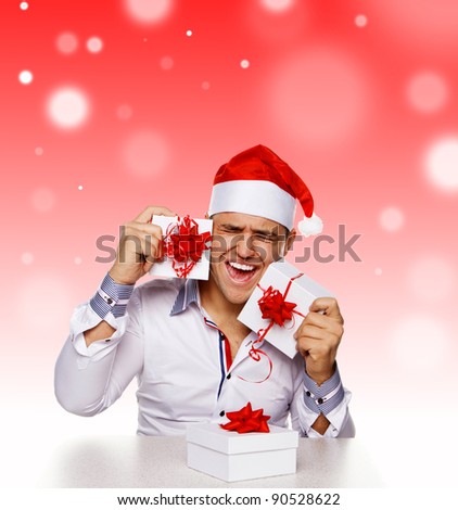 Young man with christmas gifts, isolated on white