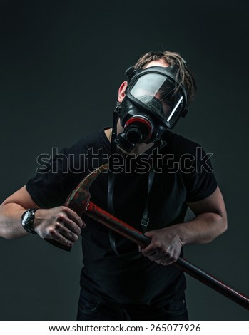 Male in oxygen mask holds axe. Isolated on grey