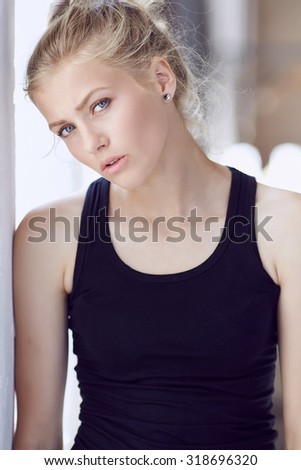 Portrait of blond woman in black shirt.