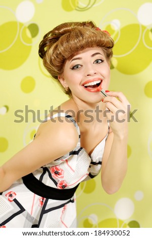 Pin-up girl with lipstick on light background
