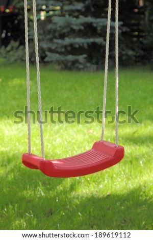 Garden swing hanging on tree.