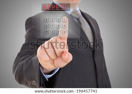 Businessman is setting code of security alarm system