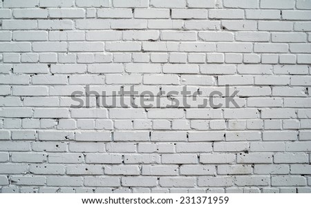 Texture of old rustic brick wall painted with white paint