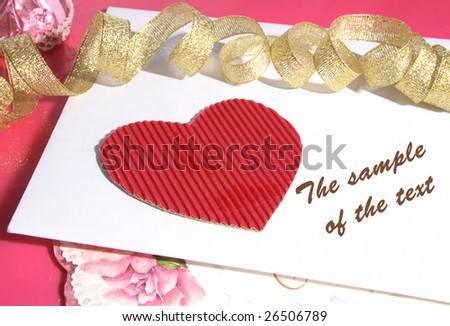 Background with cardboard heart of red color and a gold tape.