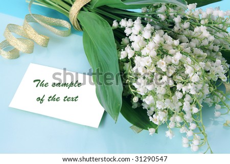 Background with a bouquet of lilies of the valley and a place for the text.