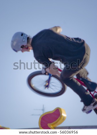 YEKATERINBURG - JUNE 26: Festival Youth Day. Demonstrative performance of extreme rollers and cyclists at the feast Day of Youth, sport bmx trial. Event 26 june, 2010 in Yetaterinburg, Russia.