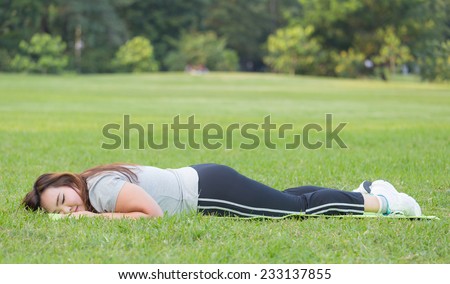 Obese woman is resting after completed her workout.
