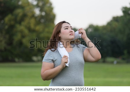 obese woman sweating while exercising.