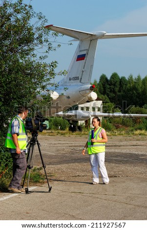 NIZHNY NOVGOROD. RUSSIA. JULY 31, 2014. STRIGINO AIRPORT. The journalist and the video operator of TV channel Russia write down the reporting on airport work.